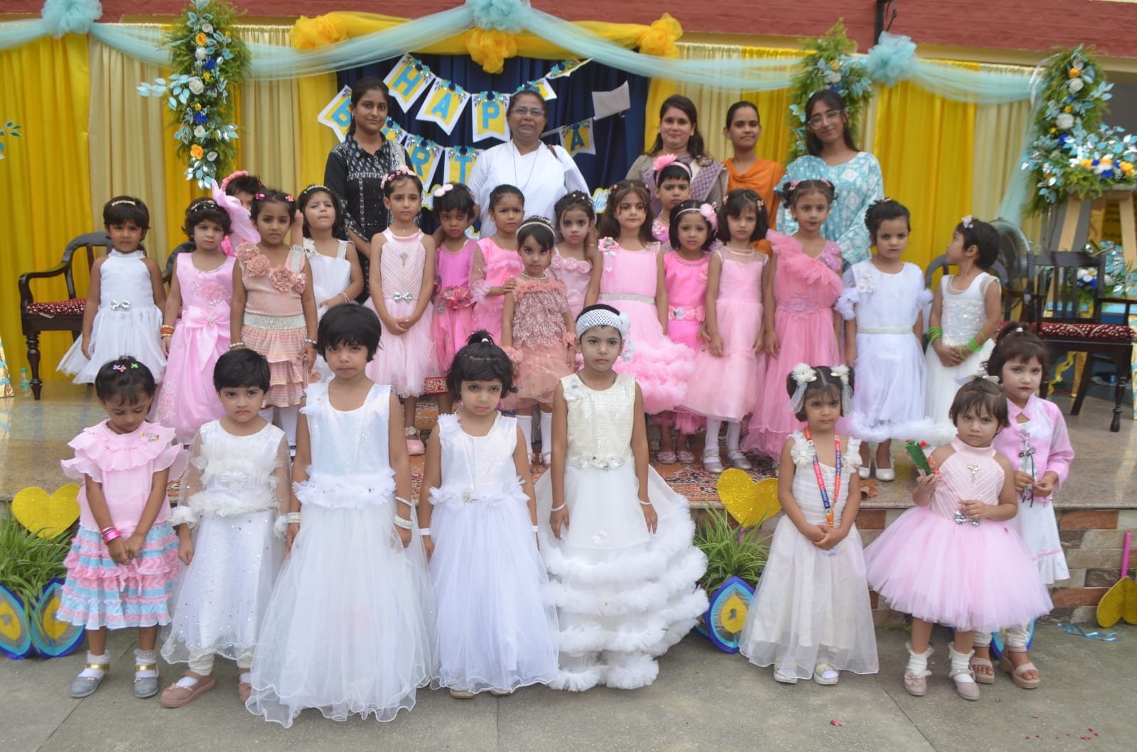 Students and staff celebrating a birthday on the school stage